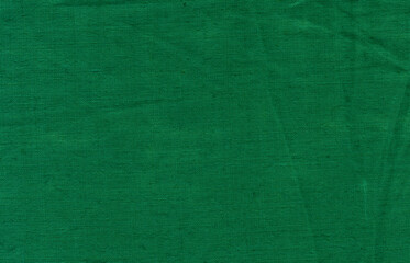 Fototapeta premium Green fabric texture background with fine textile pattern and smooth surface. Minimal modern backdrop for creative designs.