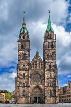 St. Lorenz church front facade view in Nuremberg, Germany. Low angle perspective of the historic building under a cloudy sky
