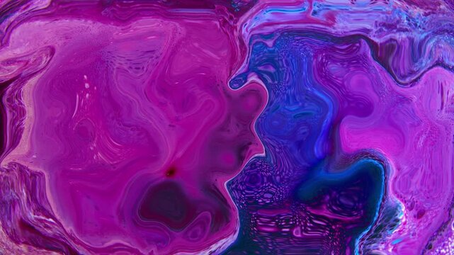 Vibrant macro shot of abstract fluid art with swirling liquid paint. Beautiful organic movement and marble patterns create a dynamic artistic background