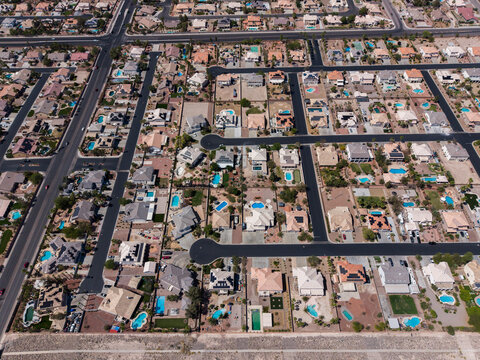Top down aerial view of a desert suburban neighborhood with cul-de-sacs and pools