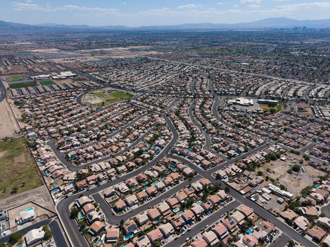 Wide aerial view of vast desert residential valley with distant mountains