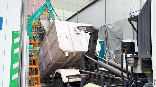 Hook Lift Truck Loading Waste Container at Tokyo Construction Site