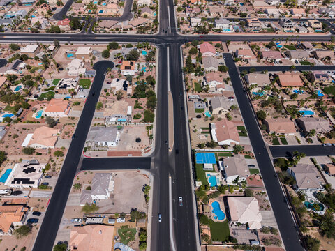 Top down aerial view of a desert suburban neighborhood with cul-de-sacs and pools