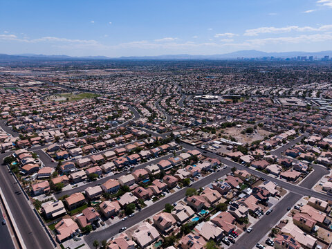 Wide aerial view of vast desert residential valley with distant mountains