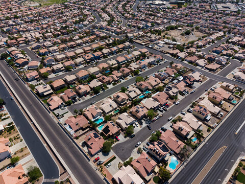 Top down aerial view of a desert suburban neighborhood with cul-de-sacs and pools