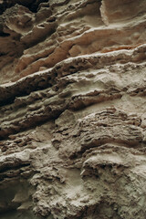 Natural limestone rock texture with layered erosion patterns rough earthy surface abstract geology background organic stone formations desert tones mineral relief and raw nature detail © Fox