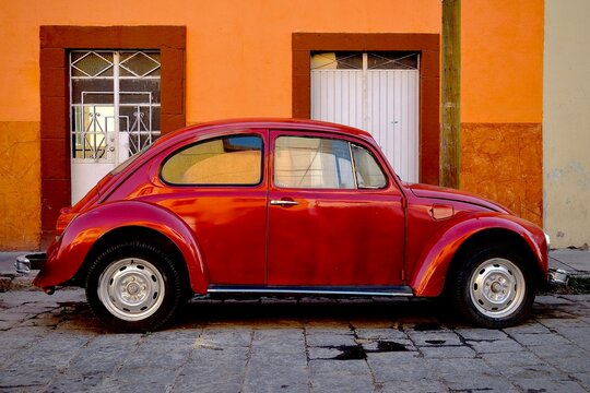 Red Volkswagen Beetle Parked Along Colorful Street (San Luis Potosi, San Luis Potosi, Mexico &ndash; May 19, 2026)