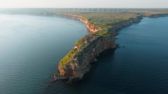 Kaliakra cape rocky peninsula black sea coast fortress ruins wind turbines drone aerial view bulgaria historical landmark steep cliffs water shore travel tourism destination summer day