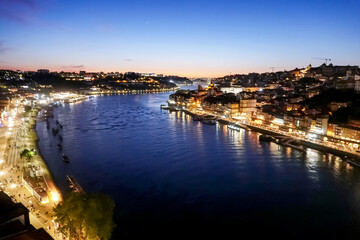 Obraz premium High angle panoramic view of illuminated Douro River and Porto cityscape at night, Portugal