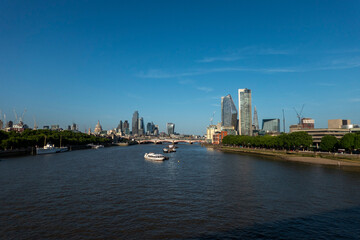 Naklejka premium London, UK, 27th May 2026 - London Skyline from Waterloo bridge showing building work in progress and the main financial district, late evening suchine, wide angle