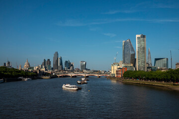 Obraz premium London, UK, 27th May 2026 - London Skyline from Waterloo bridge showing building work in progress and the main financial district, late evening suchine,mid shot