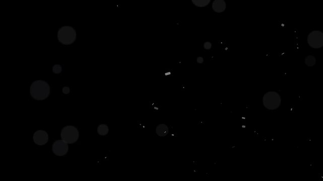 Ethereal subtle motion of abstract dust particles and bokeh lights floating and shimmering over a black background
