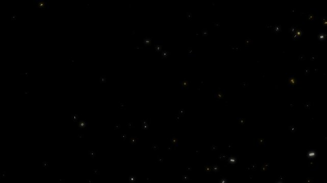 Golden warm glowing dust particles slowly floating shimmering against a black background effect video