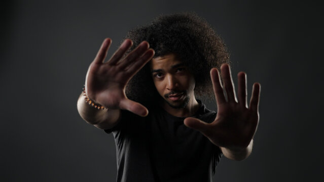 Man holding hands up, refusing or protecting with a stop gesture