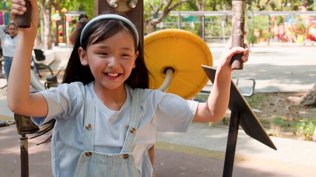 Young Thai Girl Exercising on Outdoor Gym Equipment in Lumpini Park