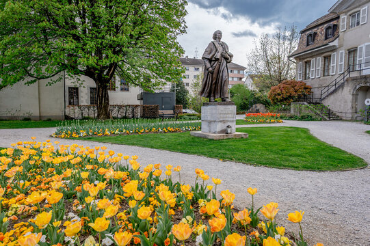 Statue of Ignacy Jan Paderewski and Spring Tulips in Historic Park in Switzerland.