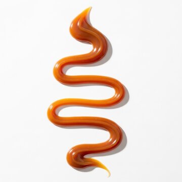 Viscous Caramel Sauce Swirl on White Background.