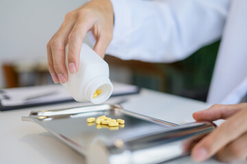 Fototapeta premium Pharmacist preparing medication counting pills for customer service in pharmacy