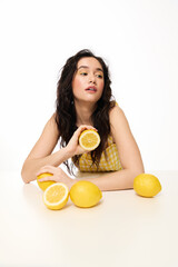 Obraz premium Summer vibes embrace a young woman with fresh lemons and stylish attire, radiating joy.
