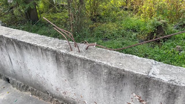 Exposed Rusty Rebar on Damaged Concrete Structure Outside