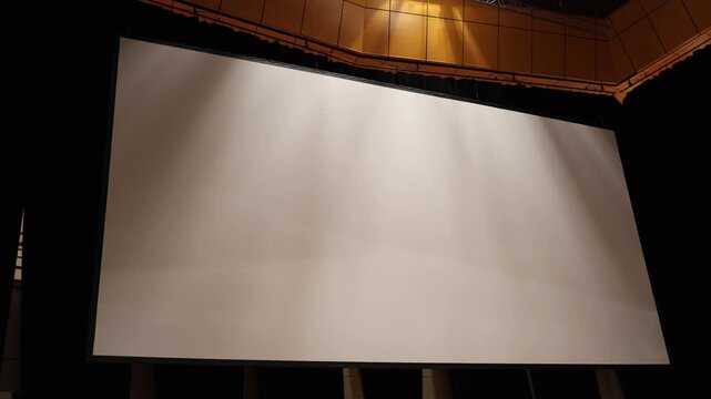 Large empty projection screen inside modern theater hall prepared for conference presentation cinema screening or live event production