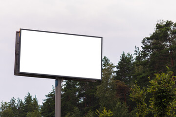 Fototapeta premium Advertising billboard along the road in the city. Background for design. 