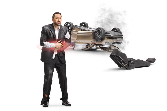 Man with abdomen injury standing by car collision