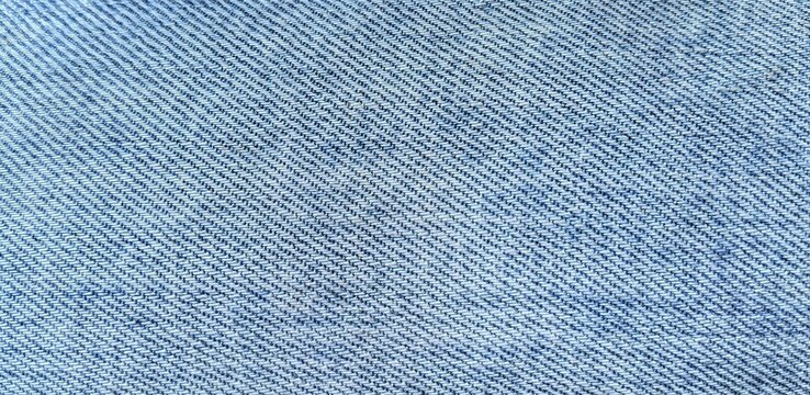 ​Close-up of light blue denim fabric texture background