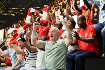 Fototapeta premium Joyful football supporters jumping after winner goal secures world championship victory, thrilling soccer match. Cheering crowd with raised fists erupting with fan joy and powerful team spirit.