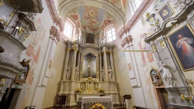 Vilnius, Lithuania &ndash; June 4, 2026: Historic Church of the Holy Cross interior highlighting the richly decorated altar and ceiling frescoes