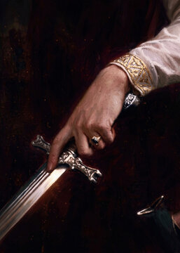 Close Up of a Noble Medieval Hand Holding a Silver Sword Hilt