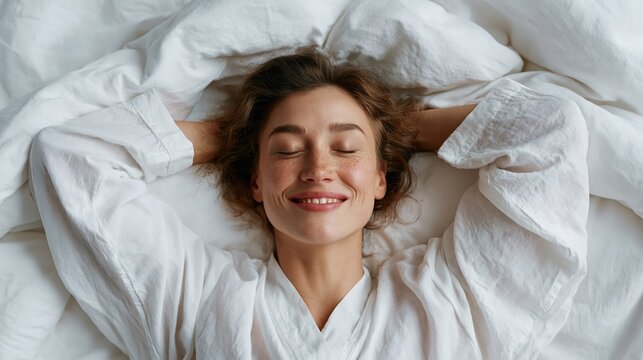 Young woman with freckles smiles peacefully while lying in bed with eyes closed