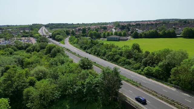 Aerial Drone View of A2 Motorway Winding Through Lush Green Woodland and Fields Hambrook Kent UK