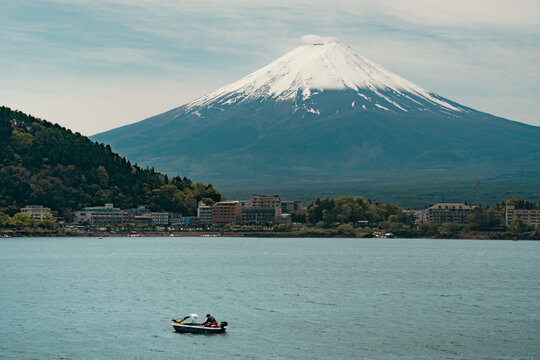 Mount Fuji viewed from Lake Kawaguchi with calm water and clear sky in Japan.