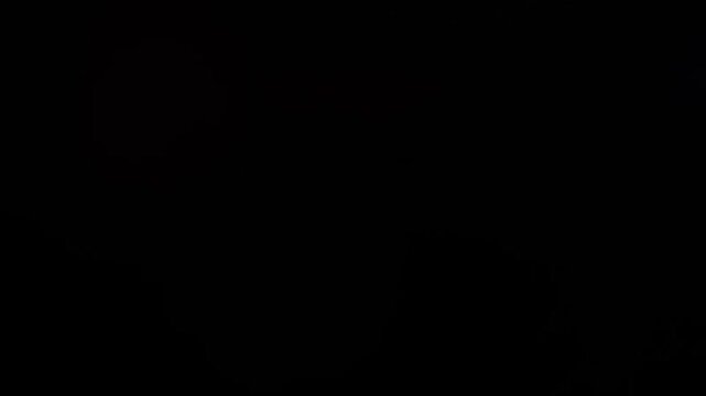 Slow motion cinematic lens flare and light leak effect isolated on black background. Perfect overlay for VFX, transitions, title reveals, film burn style and glow highlights. 4k resolution