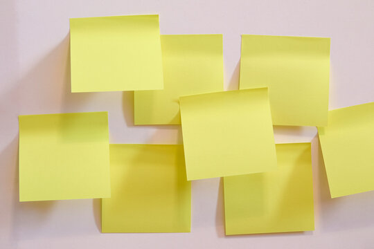 Blank yellow post it notes on wall