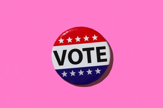 Vote pin on pink background
