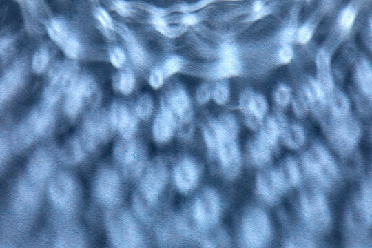 Dappled light on blue background