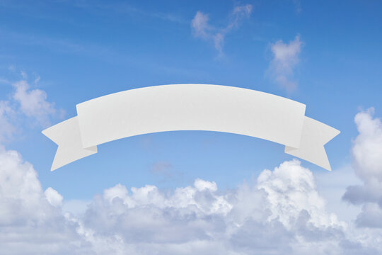 Blank banner in front of blue sky and white clouds