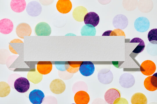 Blank banner in front of colorful confetti