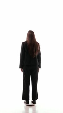 Full body 360 rotation video of woman in black office outfit with glasses. Concept of employee onboarding, dress code training, workplace etiquette, HR materials, and office style guide.