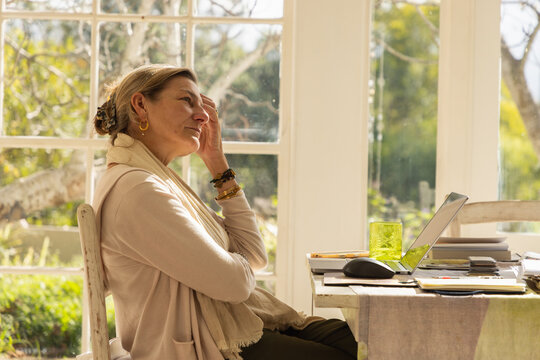 profile of adult woman typing in her home office