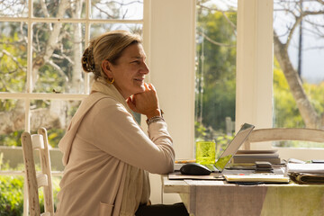 Fototapeta premium profile of adult woman typing in her home office