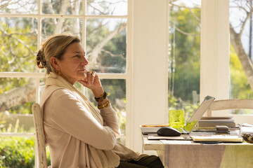 Fototapeta premium profile of adult woman typing in her home office
