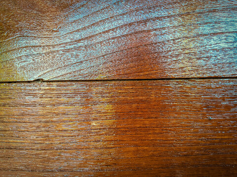 Glossy varnished brown wood grain texture background