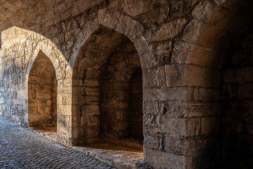 Fototapeta premium Ancient stone arches and cobblestone passage