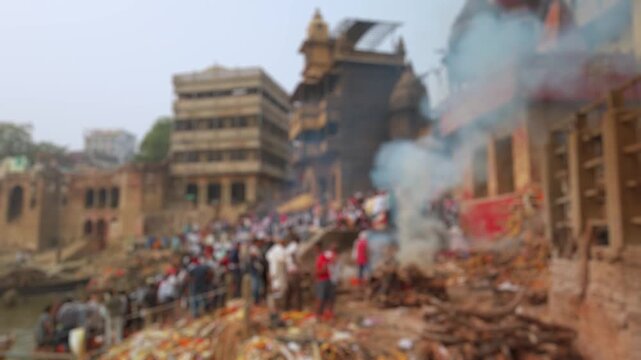 Bokeh view of Manikarnika Ghat is one of the ghats and is most known for being a place of Hindu cremation in Varanasi, India. Blurred background footage.