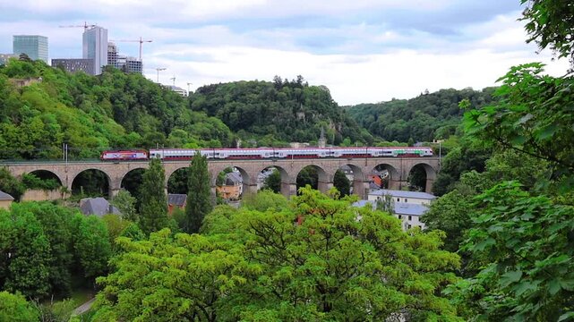 Train running ove the old stone bridge in Luxembourg city