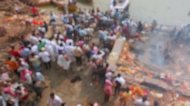 Bokeh view of Manikarnika Ghat is one of the ghats and is most known for being a place of Hindu cremation in Varanasi, India. Blurred background footage.