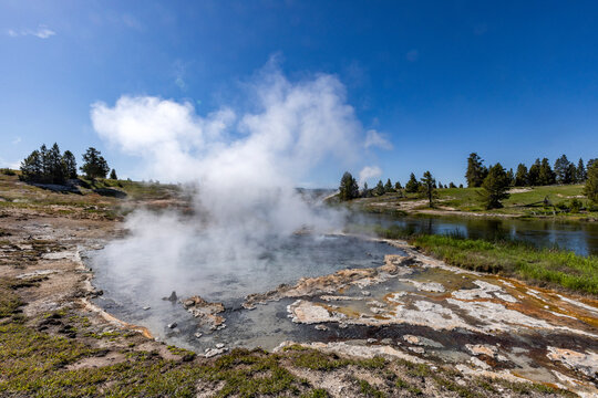 Hot spring emitting steam near Firehole River